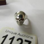 A skull ring with ruby eyes, size R.