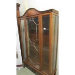 A mahogany inlaid display cabinet.