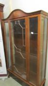 A mahogany inlaid display cabinet.