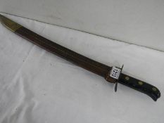 A good old machete in leather scabbard, overall length 54 cm.