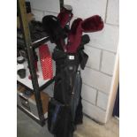 A caddy bag with golf clubs including Wilson