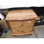 A solid pine 2 drawer bedside chest of drawers