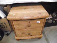 A solid pine 2 drawer bedside chest of drawers