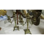 A pair of brass candelabra.