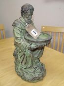 A verdigris resin figure of a monk