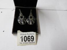 A pair of silver and plique a jour earrings.