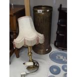 A Peerage brass umbrella stand and a table lamp