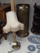 A Peerage brass umbrella stand and a table lamp