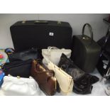 A selection of vintage handbags and suit cases