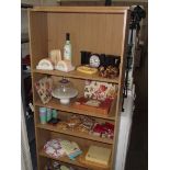 5 shelves of kitchen ware including butter dishes, bread boards, place mats etc.