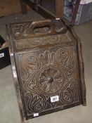 A carved Edwardian oak log/coal box with liner