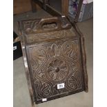 A carved Edwardian oak log/coal box with liner