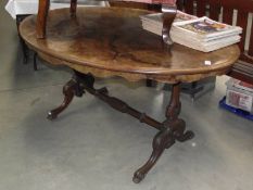 A Victorian walnut veneered oval dining table.