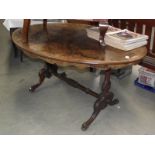 A Victorian walnut veneered oval dining table.