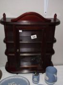 A darkwood stained collectors display cabinet