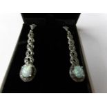 A pair of silver marcasite and opal paneled drop earrings.