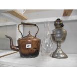 A plated brass oil lamp and a Victorian copper kettle