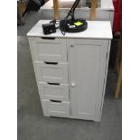 A white bathroom cupboard with drawers