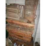 A quantity of old wooden pallets with metal feet.