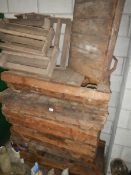 A quantity of old wooden pallets with metal feet.