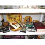 A shelf of misc. wooden items, tins, flat irons etc.