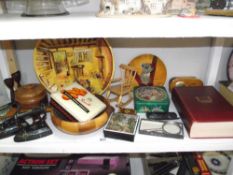 A shelf of misc. wooden items, tins, flat irons etc.