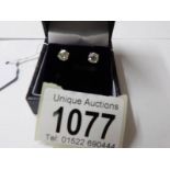 A pair of white gold diamond stud earring s of 1.21 carats.