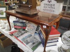 A darkwood stained coffee table with glass top