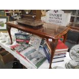 A darkwood stained coffee table with glass top