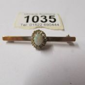 A 9ct gold bar brooch set opal, total weight 5.2 grams.