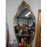 A gilt framed mirror.