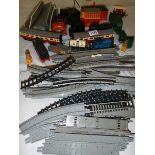 A box containing various train track and accessories.