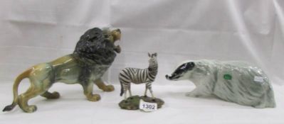 A figure of a lion (a/f), a badger by Nelson and a zebra.