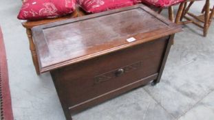 An oak lidded linen box on castors.