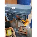 A work bench pedestal drill.