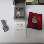 A boxed DKNY wrist watch, an aircraft related pocket watch and another wrist watch.