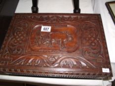 A carved teak box depicting a farmer ploughing with cattle