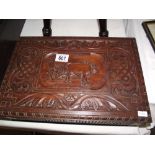 A carved teak box depicting a farmer ploughing with cattle