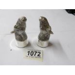 A pair of condiments in the form of horses heads, stamped 800.