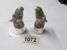 A pair of condiments in the form of horses heads, stamped 800.