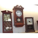 2 modern wall clocks and a mantel clock