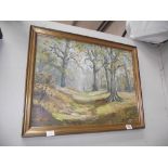A gilt framed oil on board woodland scene