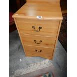 A pine effect 3 drawer bedside chest.