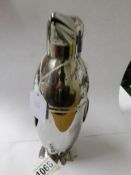 A silver plated cocktail shaker in the form of a penguin.