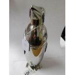 A silver plated cocktail shaker in the form of a penguin.