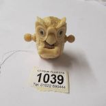 An unusual bone tape measure in the form of an owl.