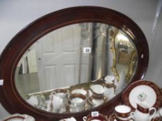 A large oval bevel edge mirror