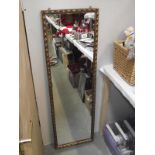 A long gilt edge mirror