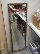 A long gilt edge mirror