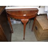 A 'D' shaped hall table on Queen Anne style legs.